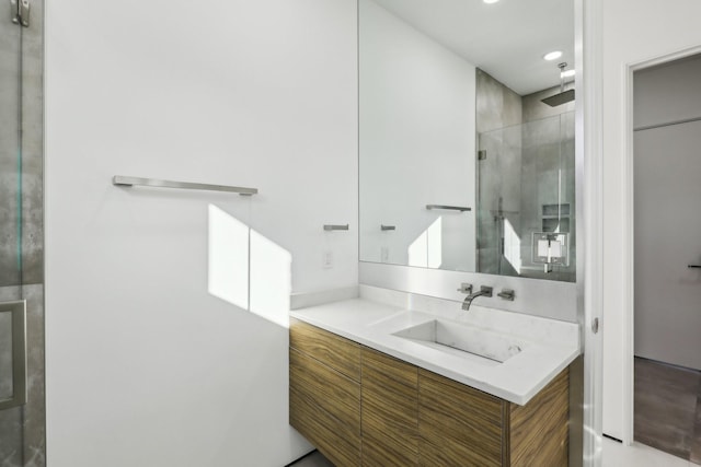 bathroom featuring an enclosed shower and vanity