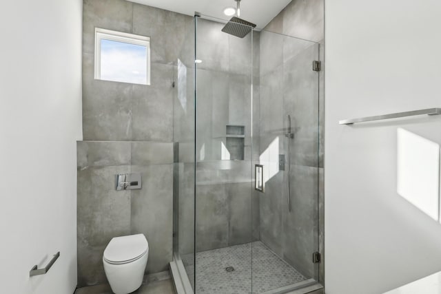 bathroom featuring toilet and walk in shower