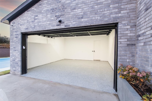 view of garage at dusk