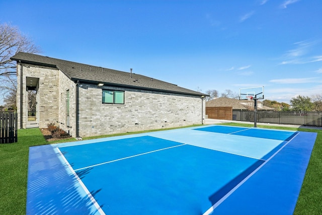 view of sport court with a lawn