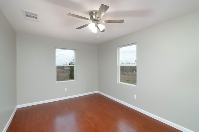 empty room featuring dark hardwood / wood-style floors and ceiling fan