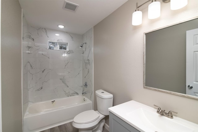 full bathroom featuring toilet, hardwood / wood-style floors, vanity, and tiled shower / bath