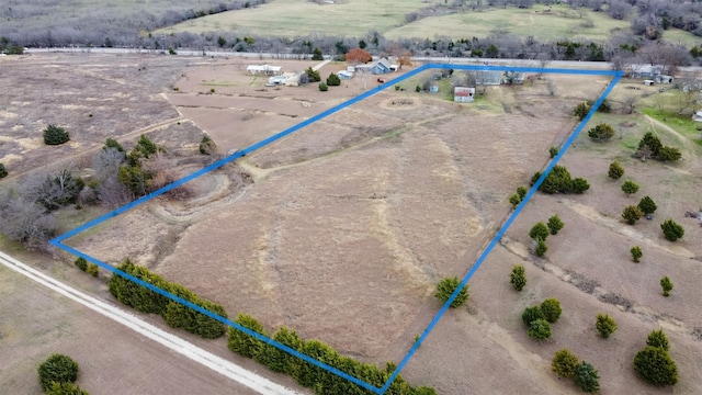 birds eye view of property with a rural view