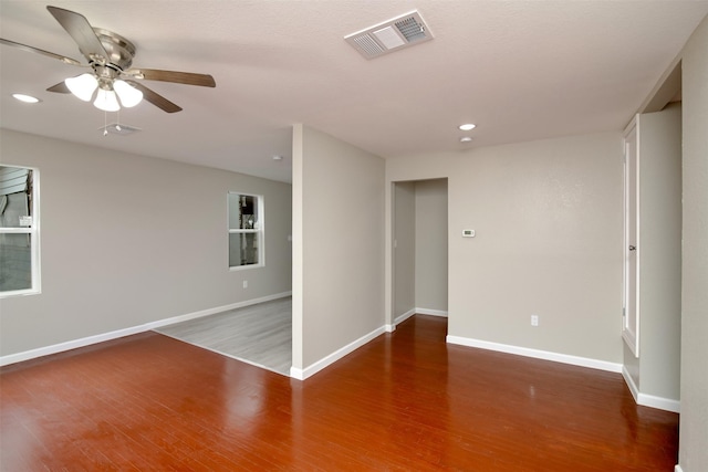 empty room with ceiling fan and hardwood / wood-style floors