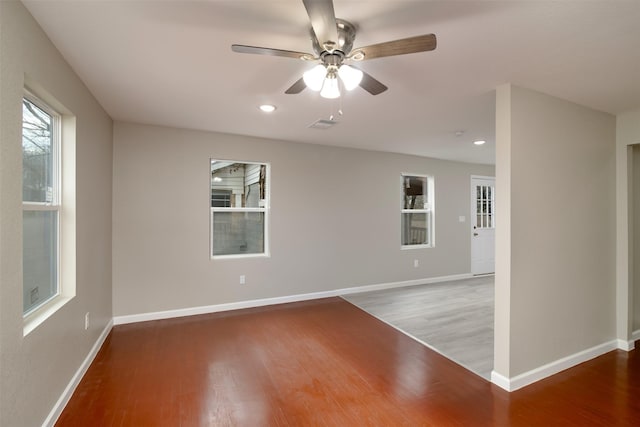 spare room featuring hardwood / wood-style floors and ceiling fan