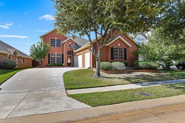 view of property featuring a front lawn and a garage