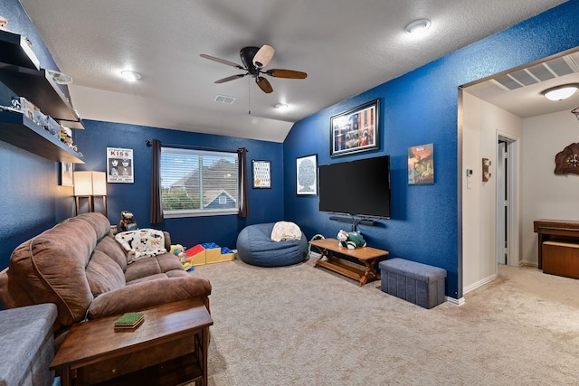 living room featuring a textured ceiling, light carpet, ceiling fan, and lofted ceiling