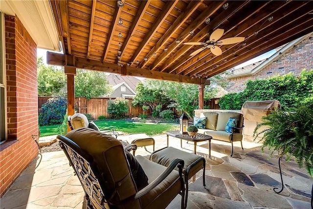 view of patio with an outdoor living space and ceiling fan