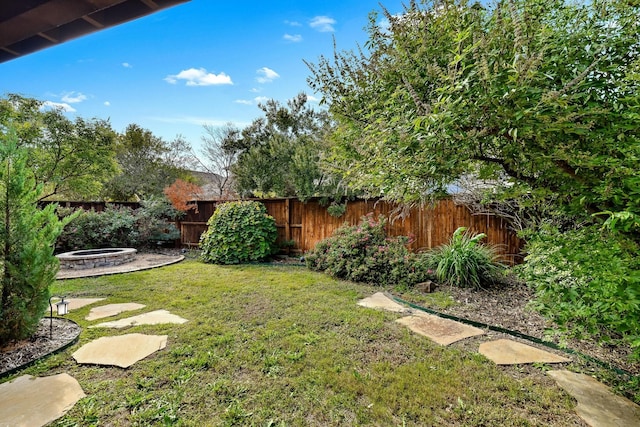 view of yard with an outdoor fire pit