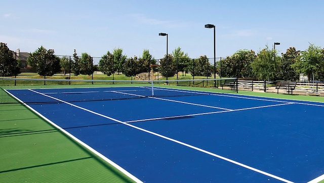 view of tennis court featuring basketball hoop