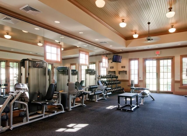 workout area with a raised ceiling, crown molding, french doors, and wood ceiling