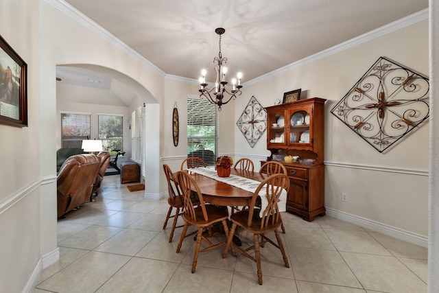 tiled dining area with an inviting chandelier and crown molding