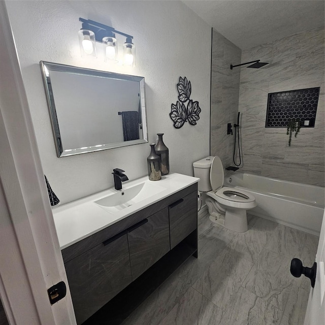 full bathroom with tiled shower / bath, vanity, and toilet