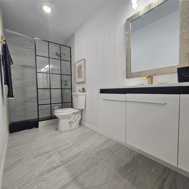 bathroom featuring vanity, toilet, and a tile shower