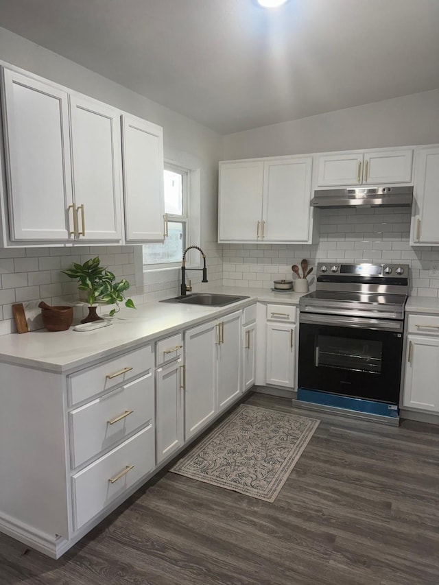 kitchen with dark wood-type flooring, sink, electric range, decorative backsplash, and white cabinets