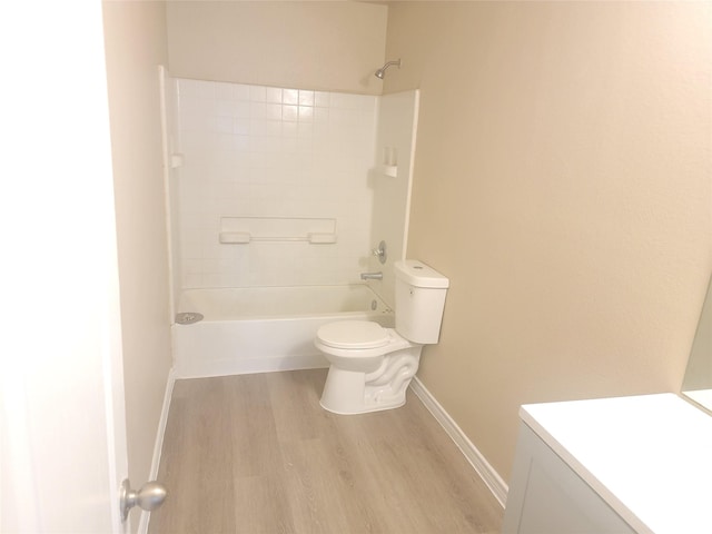 full bathroom with bathtub / shower combination, wood-type flooring, vanity, and toilet