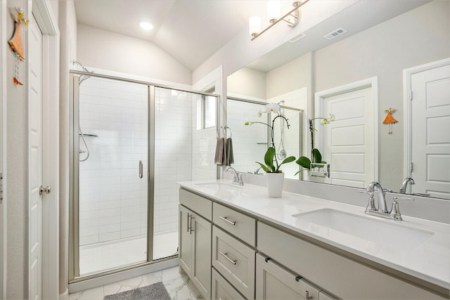 bathroom featuring a shower with door, vaulted ceiling, and vanity