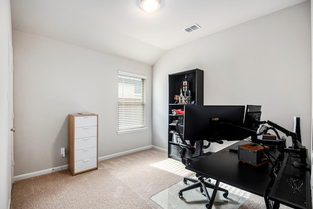 carpeted home office featuring lofted ceiling