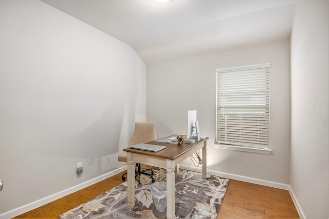 office with hardwood / wood-style flooring and vaulted ceiling