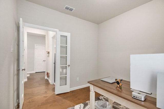 office area featuring wood-type flooring and radiator heating unit