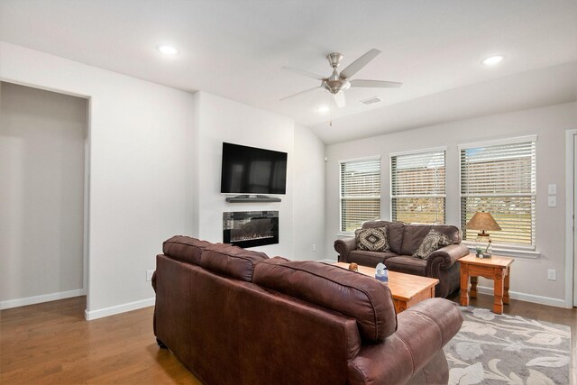 living room with lofted ceiling, light wood-type flooring, and ceiling fan