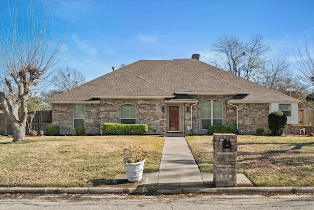 single story home featuring a front lawn