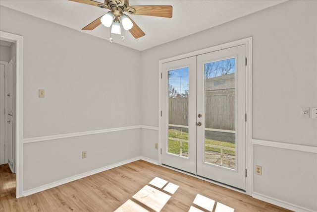 interior space featuring a textured ceiling, ceiling fan, light hardwood / wood-style flooring, and french doors