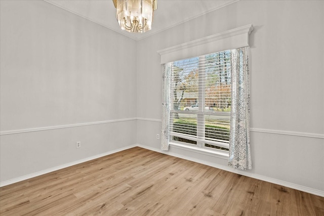 unfurnished room with a chandelier and wood-type flooring