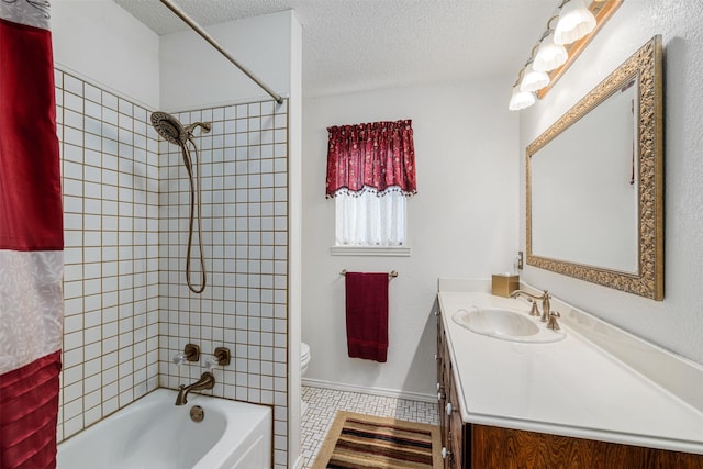 full bathroom featuring shower / tub combo with curtain, vanity, toilet, and a textured ceiling