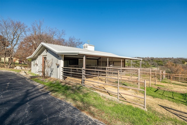 view of horse barn with a rural view