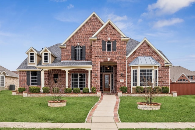 front facade featuring a front lawn and central AC