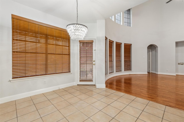 entryway featuring light tile patterned floors and an inviting chandelier