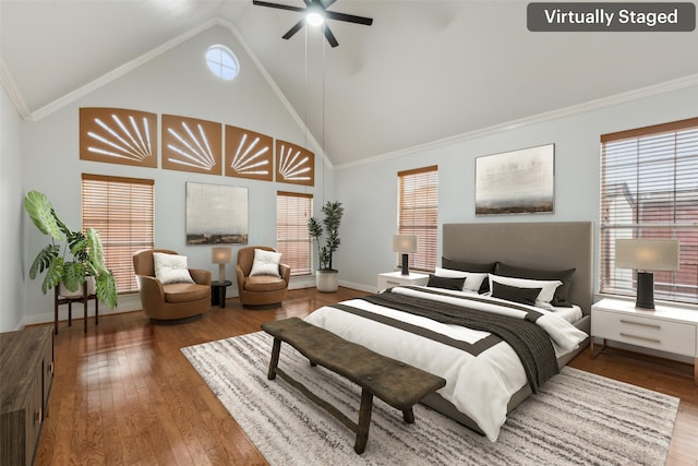 bedroom featuring ceiling fan, hardwood / wood-style floors, high vaulted ceiling, and ornamental molding