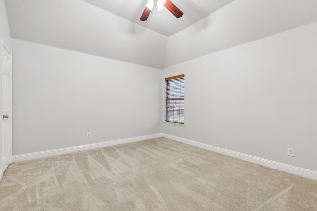 carpeted empty room with ceiling fan and lofted ceiling