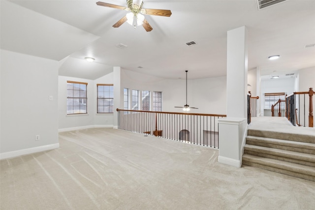 unfurnished room featuring ceiling fan, light carpet, and vaulted ceiling