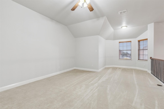 bonus room featuring ceiling fan, vaulted ceiling, and light carpet