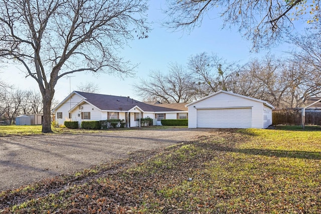 ranch-style house featuring an outdoor structure and a front lawn