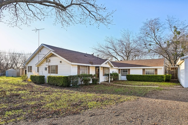 single story home featuring a storage shed