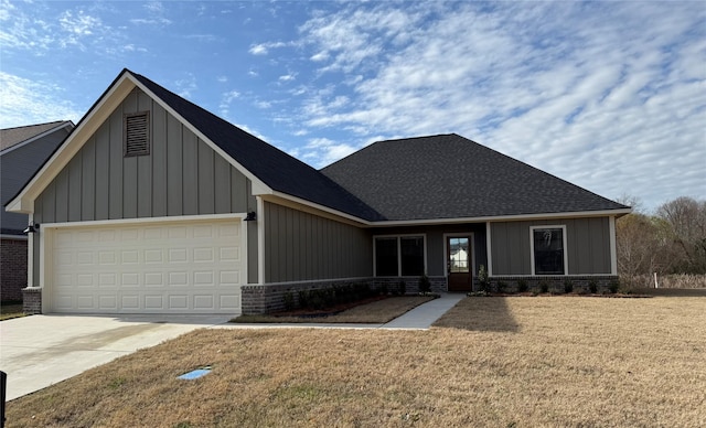 view of front of home with a front lawn and a garage