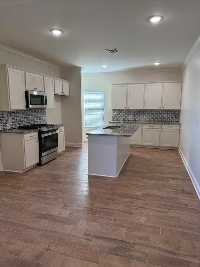 kitchen featuring white cabinetry, stainless steel appliances, sink, and wood-type flooring