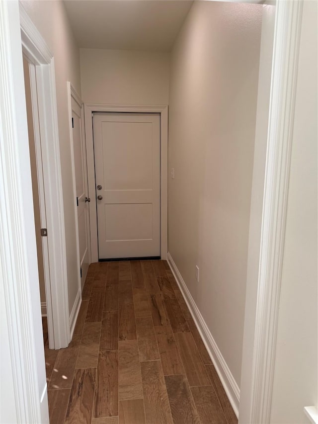 hall with dark wood-type flooring