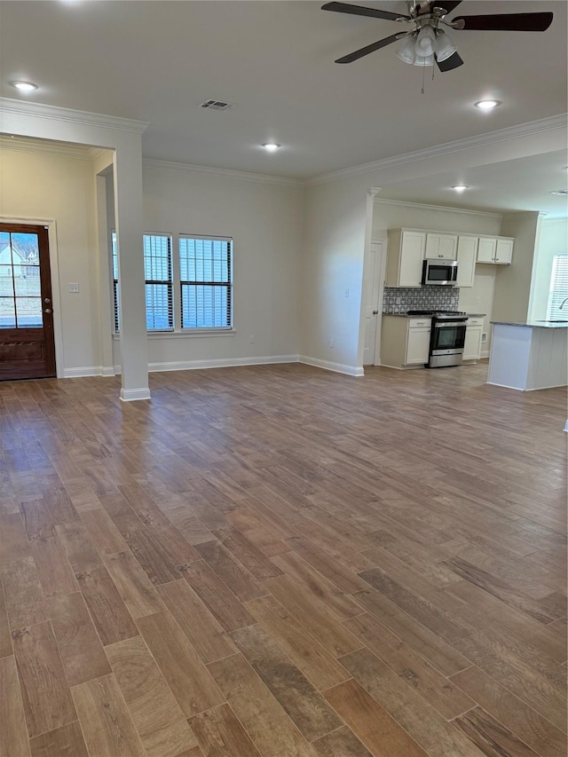 unfurnished living room with ceiling fan, crown molding, and light hardwood / wood-style flooring