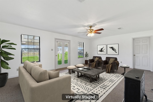 living room featuring carpet flooring and ceiling fan