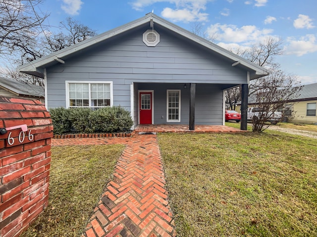 bungalow with a front lawn and a porch