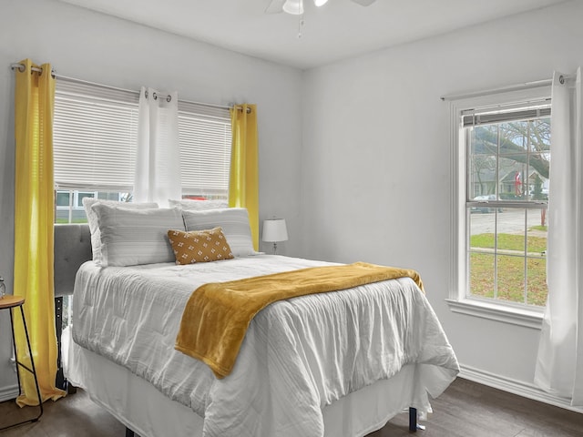 bedroom with ceiling fan and hardwood / wood-style flooring