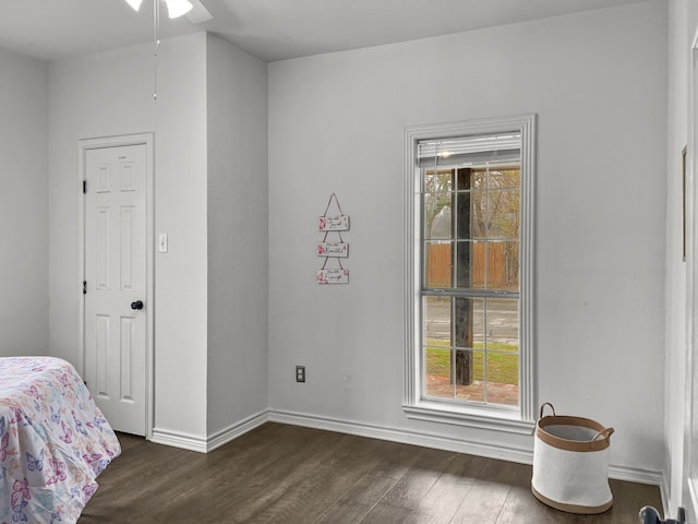 bedroom featuring multiple windows, dark hardwood / wood-style flooring, and ceiling fan