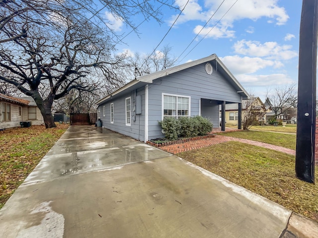 view of side of home with a yard