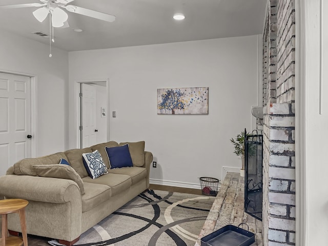 living room featuring hardwood / wood-style floors and ceiling fan