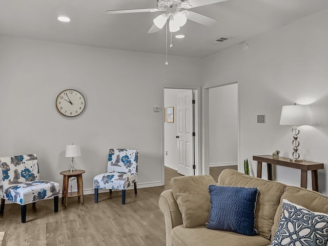 living area with ceiling fan and hardwood / wood-style floors