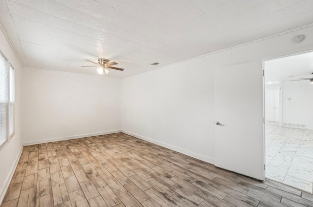 spare room with ceiling fan and light wood-type flooring